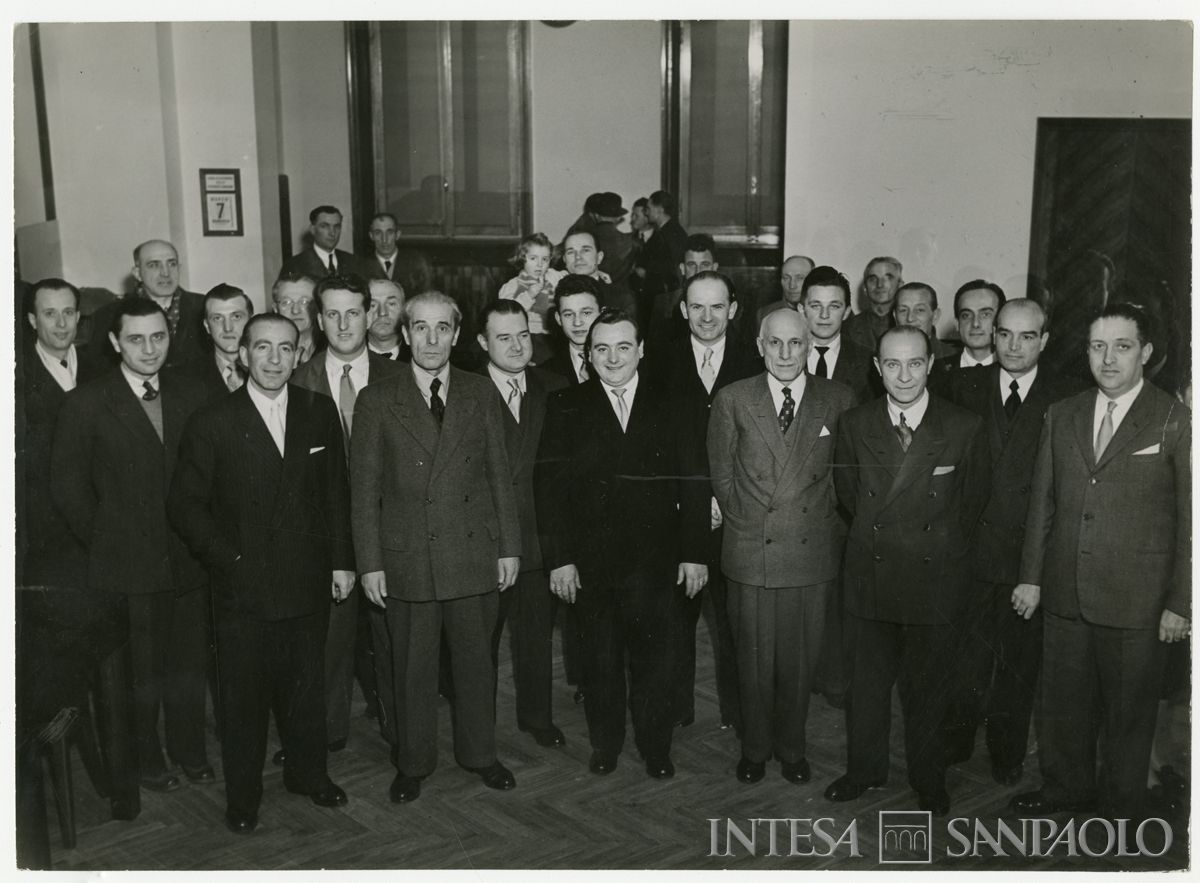 Foto di gruppo all'interno della filiale Cariplo di Parabiago, in via S. Michele 5, il giorno dell'inaugurazione, 7 marzo 1948 ("Terreni" Attualità fotografica "Reporter")