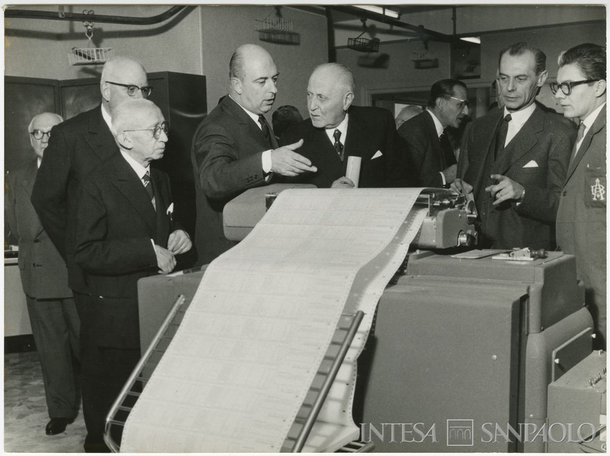 Nuovo macchinario del centro elettro-contabile del Banco Ambrosiano di Milano mostrato al presidente dell'Istituto Tommaso Gallarati Scotti (al centro), 10 dicembre 1958 (Publifoto)