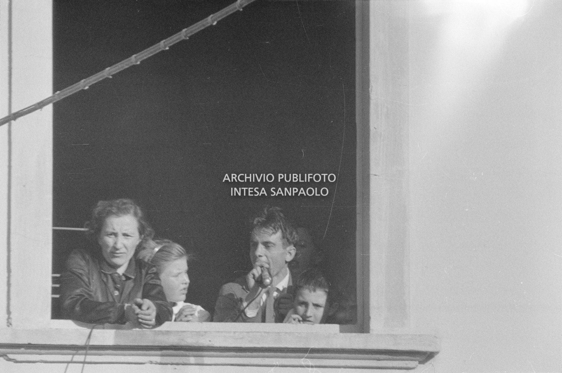 Arturo Santato, parla al microfono, alla finestra della scuola elementare di Terrazzano, frazione di Rho in provincia di Milano, a fianco a una delle maestre che ha sequestrato, insieme agli alunni e ad altre due maestre, con il fratello Egidio