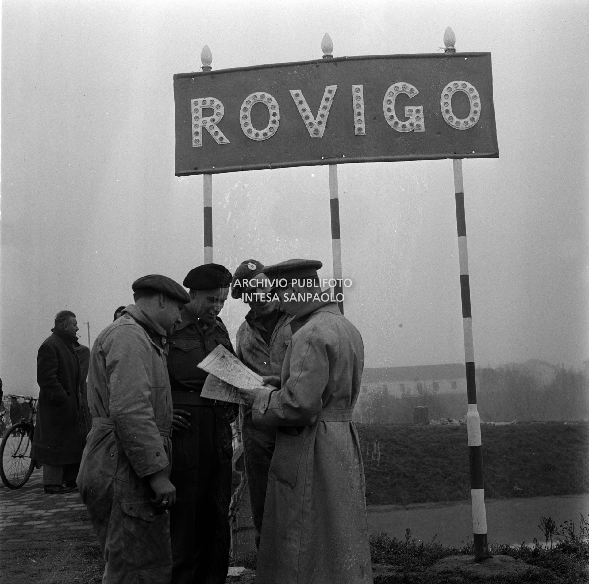 Alcuni militari, accorsi nel Polesine alluvionato, sotto il segnale di ingresso a Rovigo