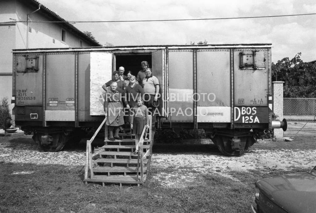 Una famiglia ritratta all'entrata del vagone ferroviario adibito ad abitazione in una delle località colpita dal terremoto in Friuli