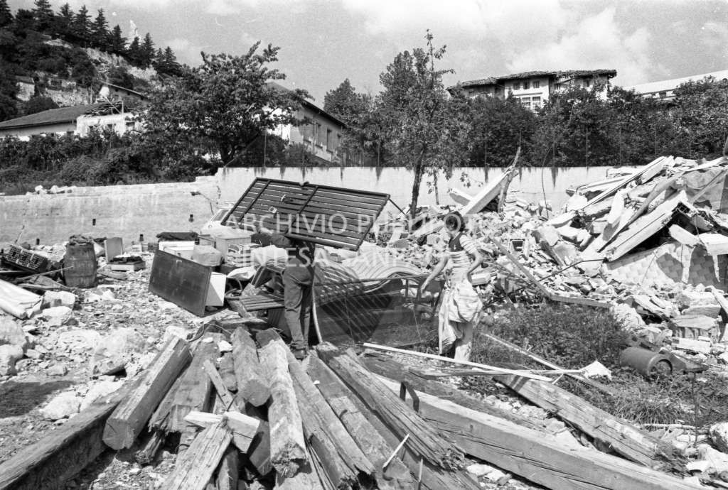 Un uomo e una donna al lavoro tra le macerie in una località del Friuli colpita dal terremoto