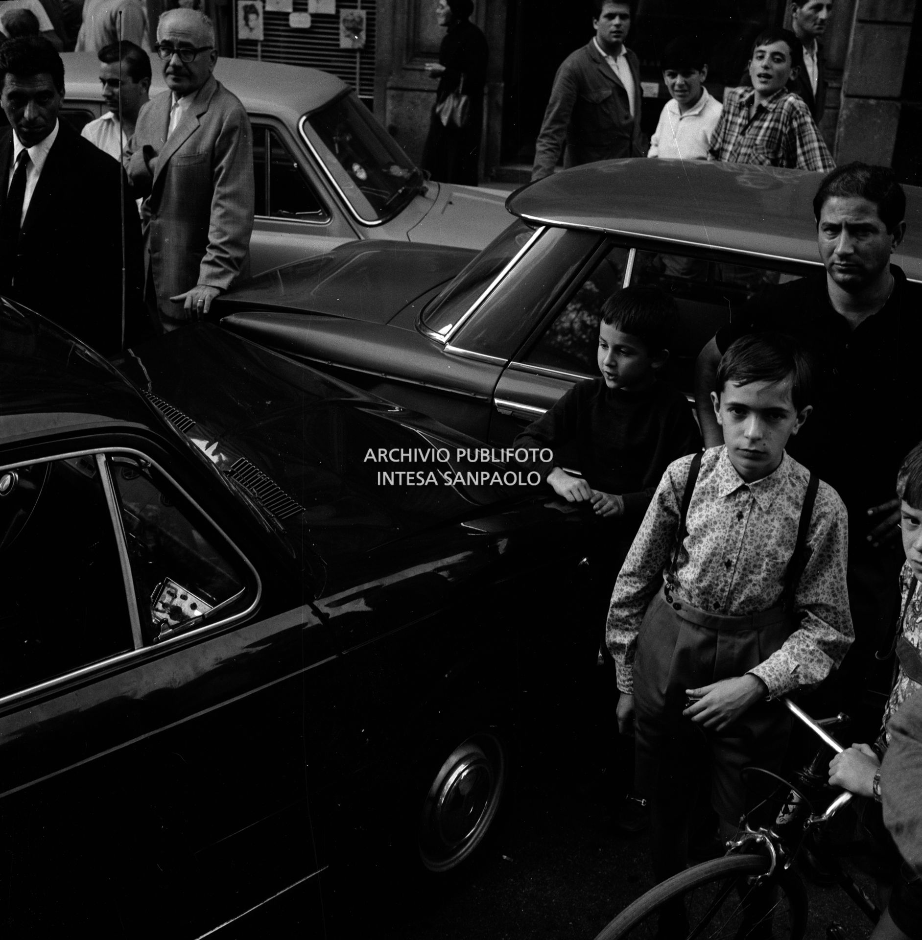 Folla di gente in via Bertani a Milano dove una Fiat 850 e una Fiat 1500 si sono scontrate per evitare l'automobile della banda Cavallero in fuga dopo la rapina all'agenzia del Banco di Napoli di largo Zandonai