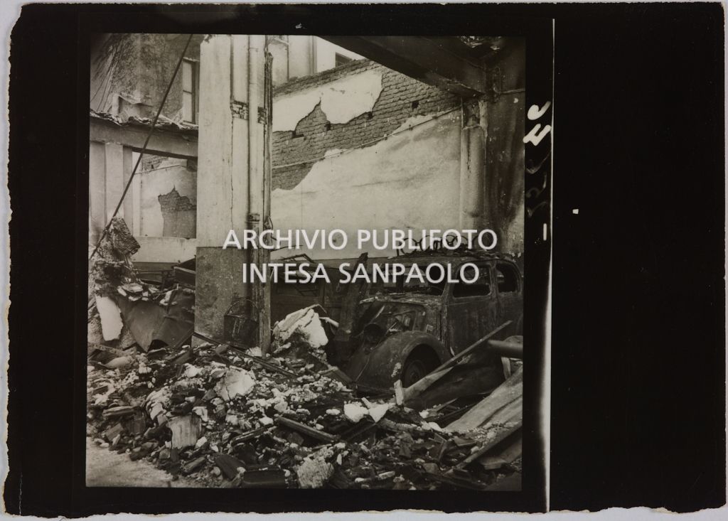 Automobili ricoverate presso l'autorimessa di proprietà della Rinascente, in viale Coni Zugna a Milano, distrutte dai bombardamenti che hanno colpito l'edificio