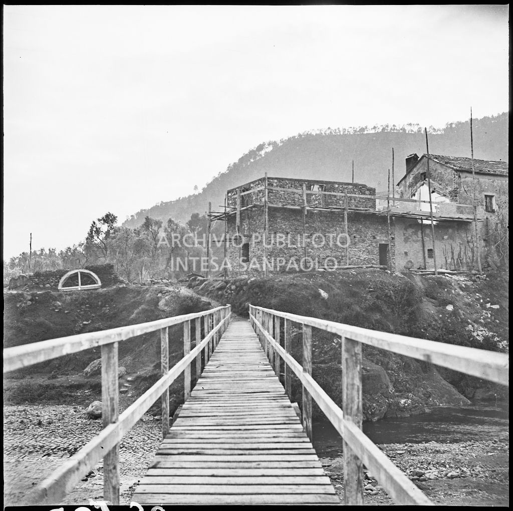 Ponte pedonale che attraversa il torrente nei pressi dello stabilimento Belsana che si intravede sullo sfondo<br>26736