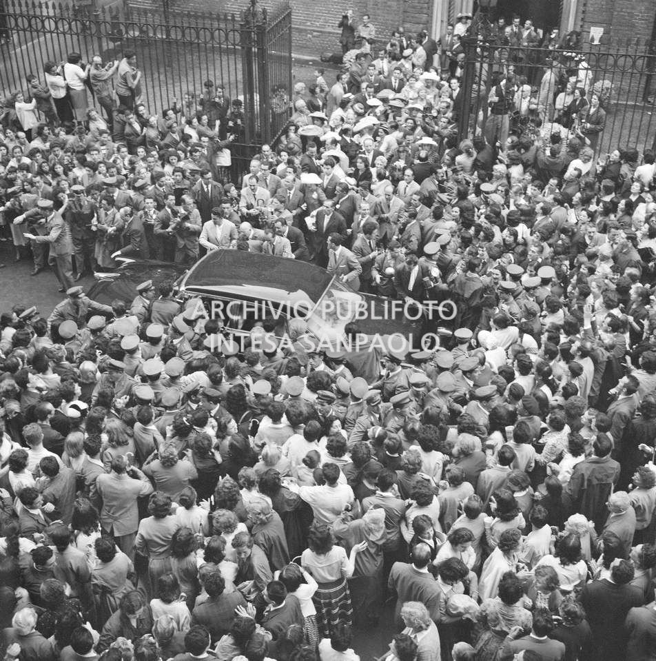 Folla intorno all'automobile che accompagna Edy Campagnoli e il calciatore Lorenzo Buffon il giorno del loro matrimonio che si è appena celebrato nella chiesa di San Gottardo in Corte a Milano