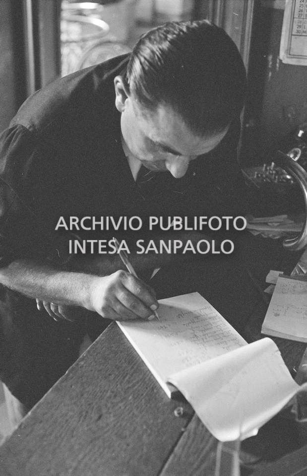 Il meccanico Giuseppe De Grandi, detto Pinella, prende appunti durante la preparazione della bicicletta di Roger Rivière in vista del record dell'ora che il ciclista francese si sarebbe aggiudicato di lì a tre giorni
