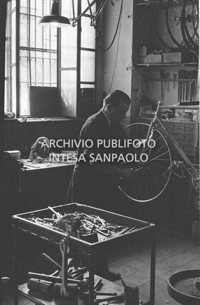 Il meccanico Giuseppe De Grandi, detto Pinella, prepara la bicicletta di Roger Rivière in vista del record dell'ora che il ciclista francese si sarebbe aggiudicato di lì a tre giorni