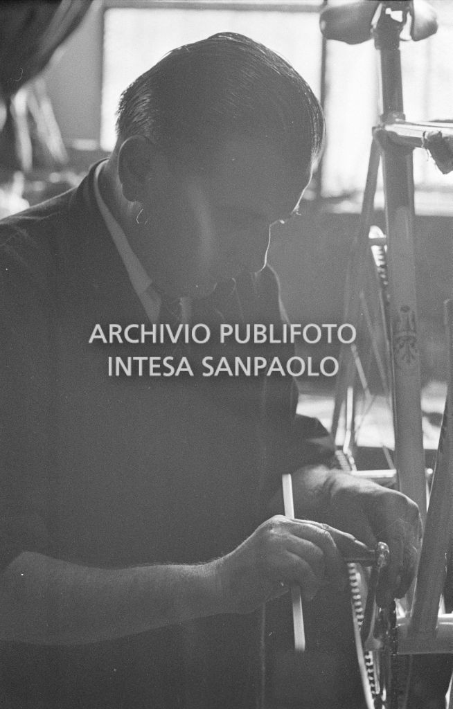 Il meccanico Giuseppe De Grandi, detto Pinella, prepara la bicicletta di Roger Rivière in vista del record dell'ora che il ciclista francese si sarebbe aggiudicato di lì a tre giorni