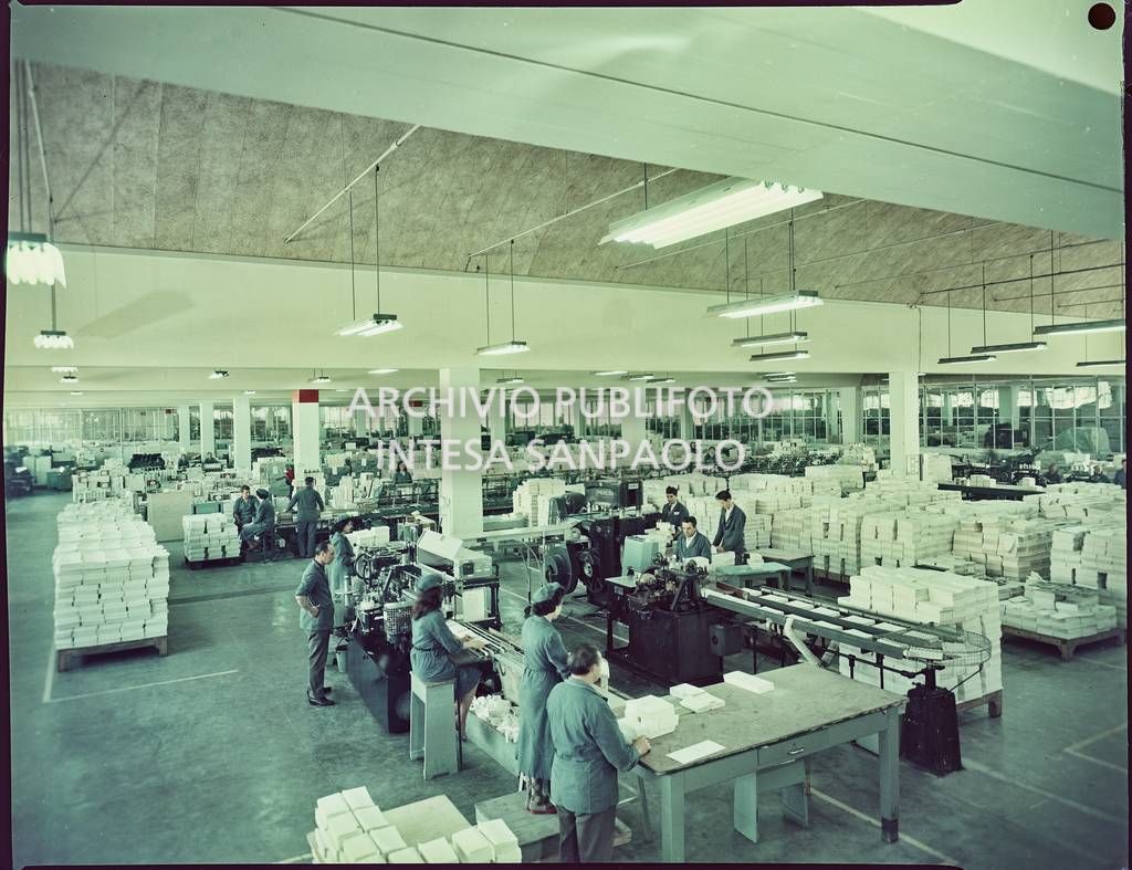 Vista dell'interno dello stabilimento Mondadori a Verona con operai al lavoro nel reparto adibito alla legatura