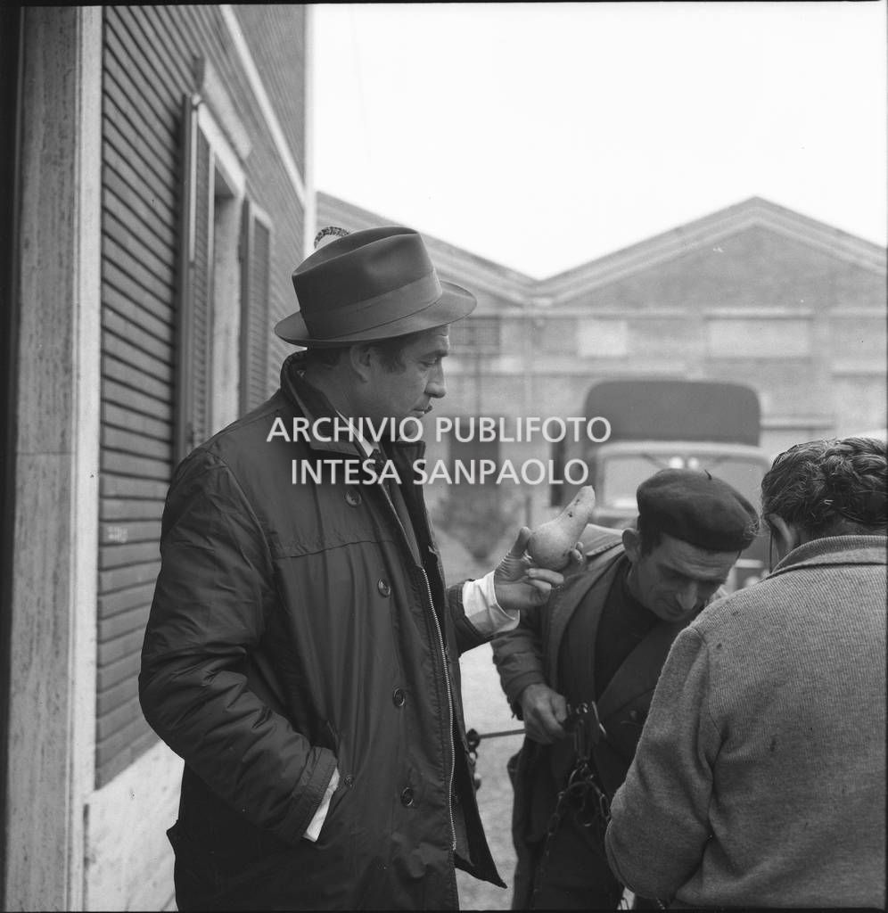 Ugo Tognazzi ritratto con una pera in mano durante le riprese dell'episodio "Gente moderna" del film "Alta infedeltà" diretto da Mario Monicelli<br>712229/1
