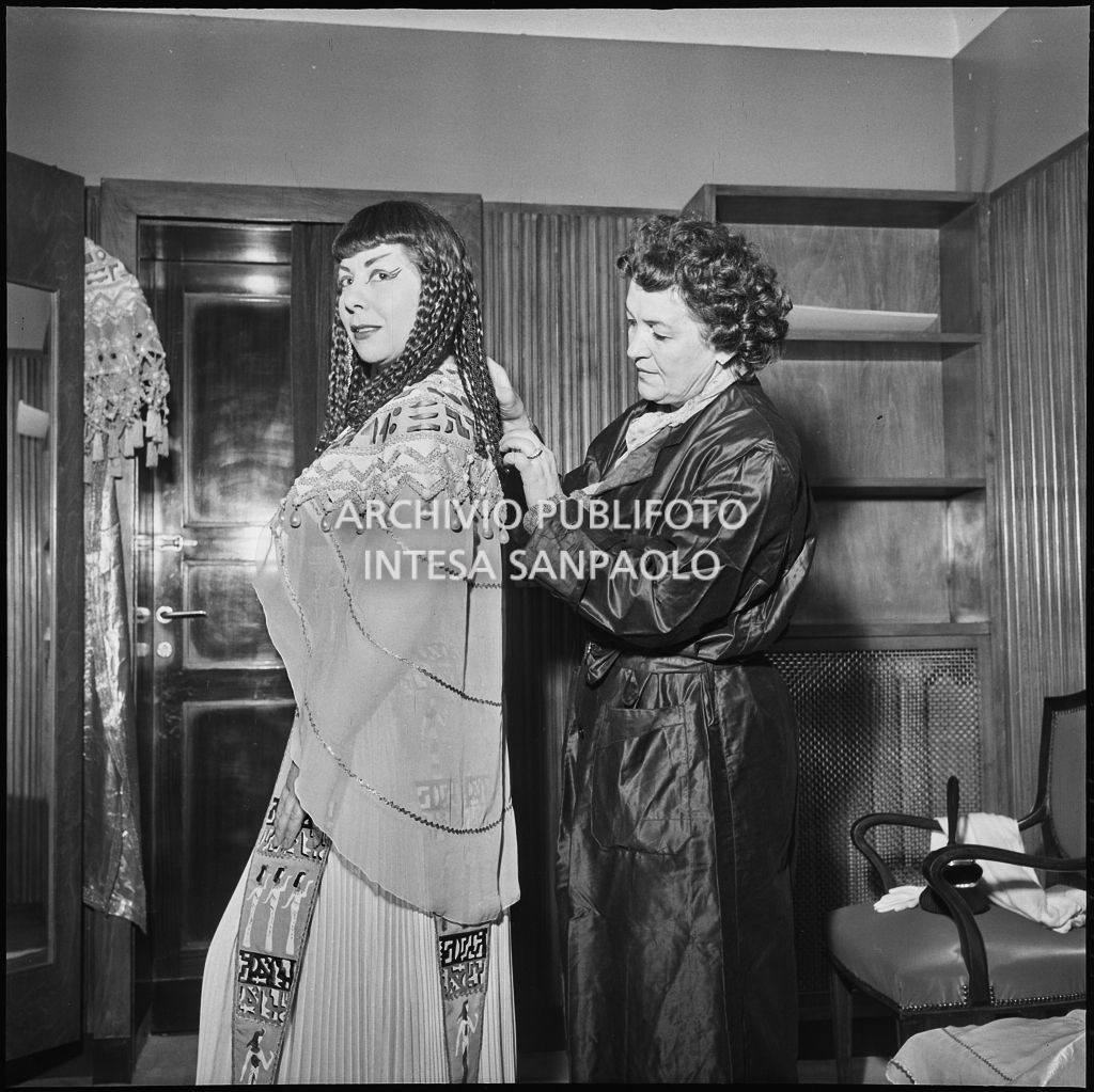Il mezzosoprano Giulietta Simionato in camerino con la sarta Novi la sera dell'inaugurazione della stagione lirica 1956-1957 del Teatro alla Scala, con l'opera "Aida" di Giuseppe Verdi, diretta da Antonino Votto, con la regia di Franco Enriquez, nella quale intrepreta Amneris