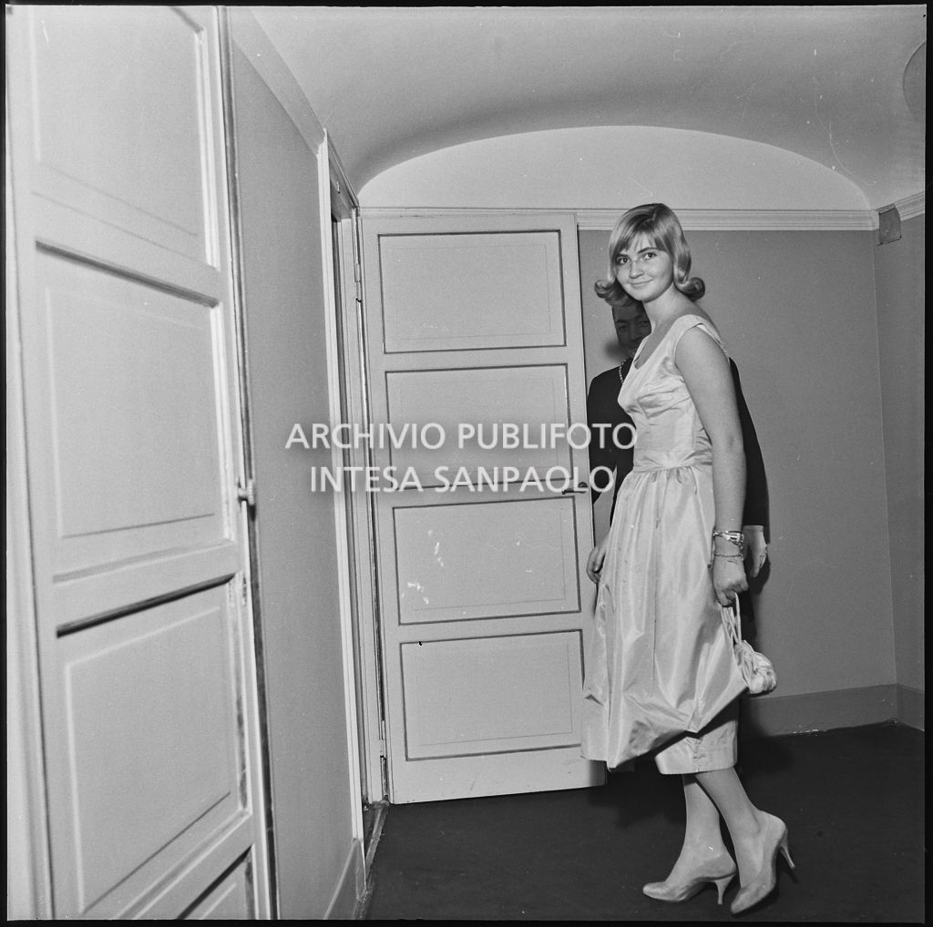 Lu Austoni sulla soglia di un palco al Teatro alla Scala in occasione della serata inaugurale della stagione lirica 1956-1957 con l'opera "Aida" di Giuseppe Verdi, diretta da Antonino Votto, con la regia di Franco Enriquez