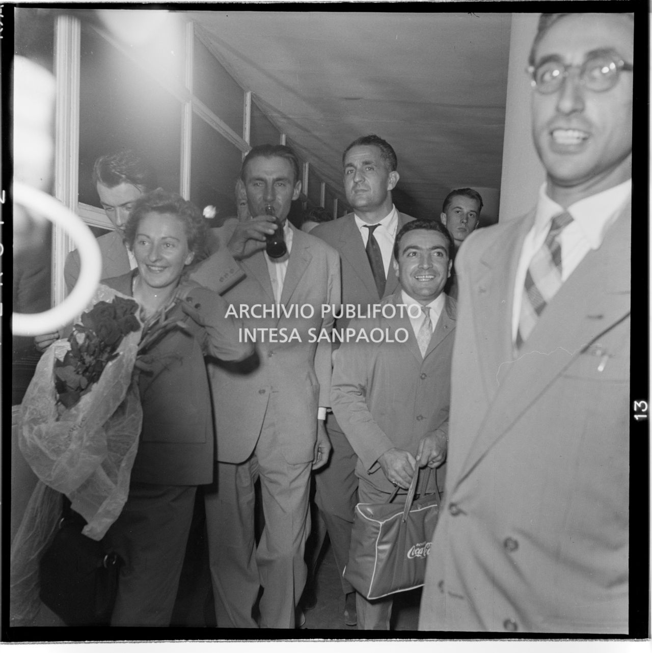 Ubaldo Rey, preceduto tra gli altri dalla moglie, al suo arrivo all'aeroporto di Linate a Milano, beve una bibita