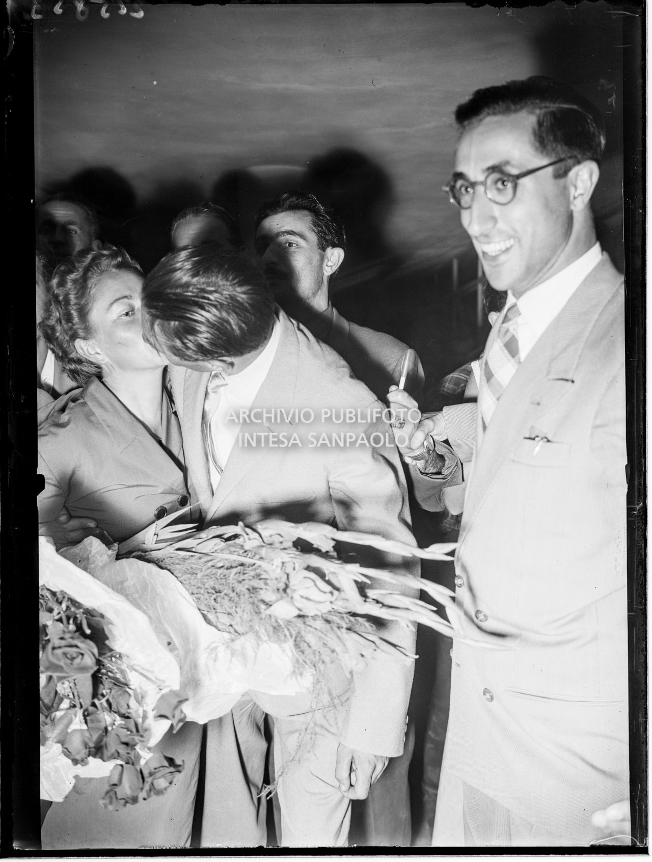 Ubaldo Rey bacia la moglie all'aeroporto Linate a Milano dove è appena arrivato insieme a Achille Compagnoni, Guido Pagani e Mario Fantin