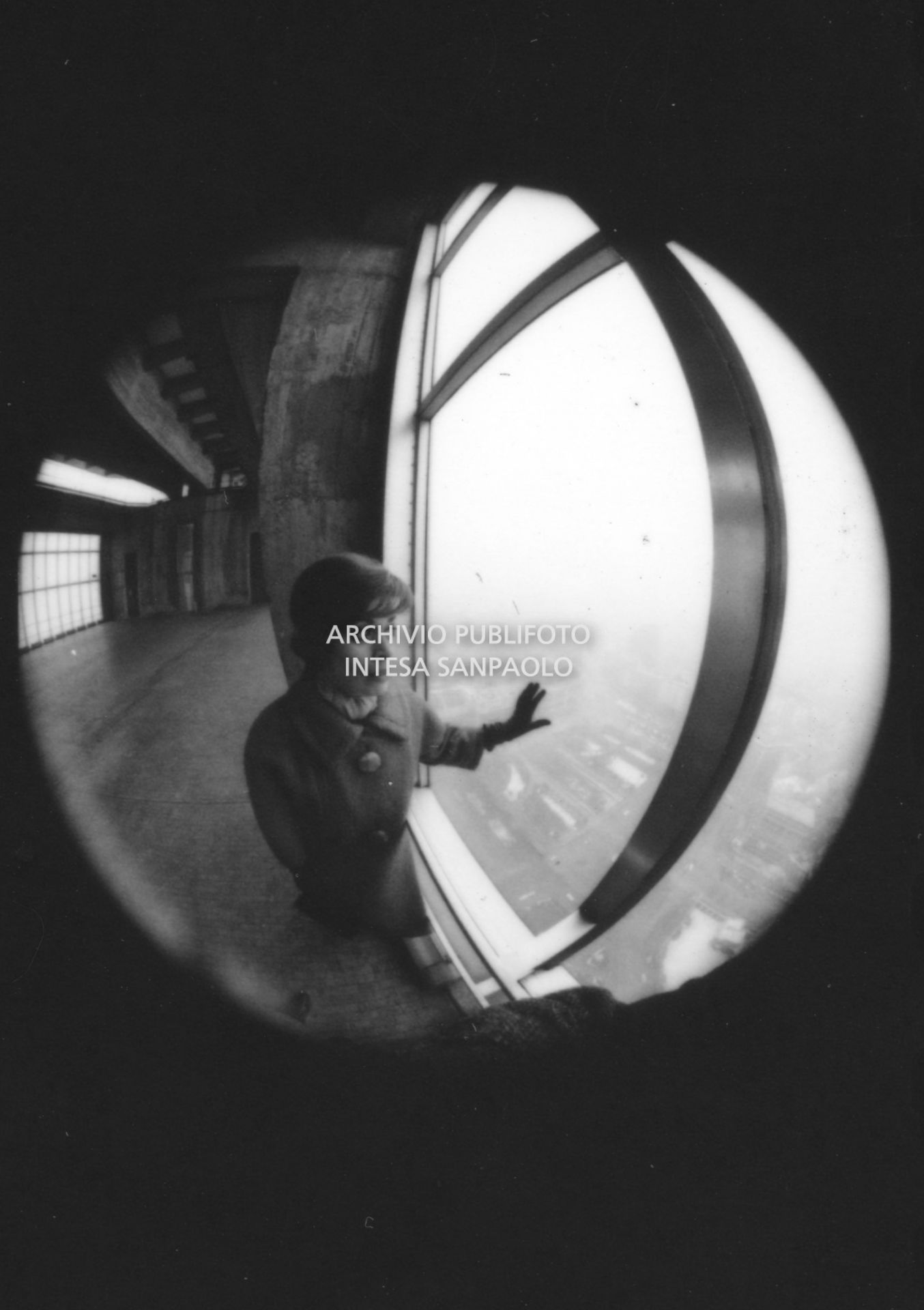 Ritratto di Franca Valeri, con un obiettivo fisheye, mentre guarda il panorama dal grattacielo Pirelli a Milano