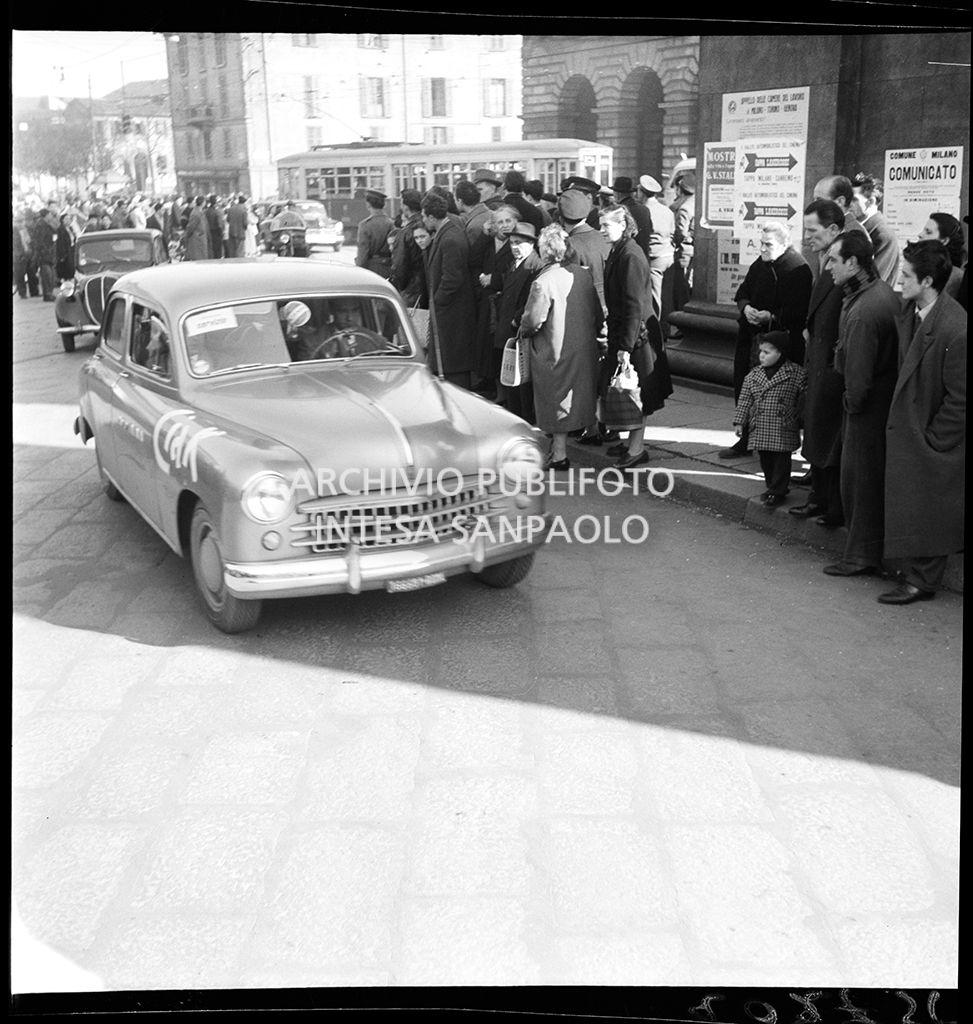 Una Fiat 1400 corre la tappa Milano-Sanremo, per le vie di Milano, del 1° Rallye automobilistico del cinema