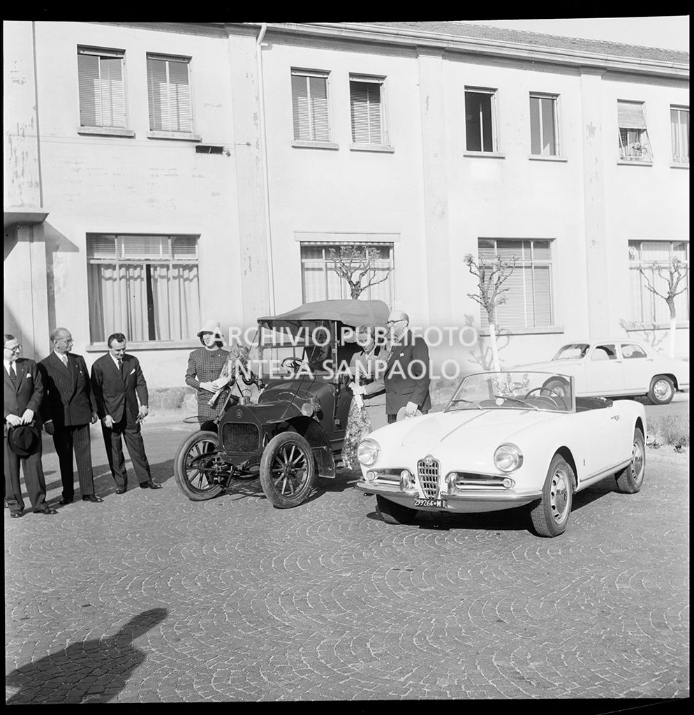 Il sindaco di Londra Cullum Welch con la moglie Gertrude Evelyn Sladin Harrison appena scesa da una Darracq 8-10 HP; a destra un'Alfa Romeo Giulietta Spider presso lo stabilimento del Portello