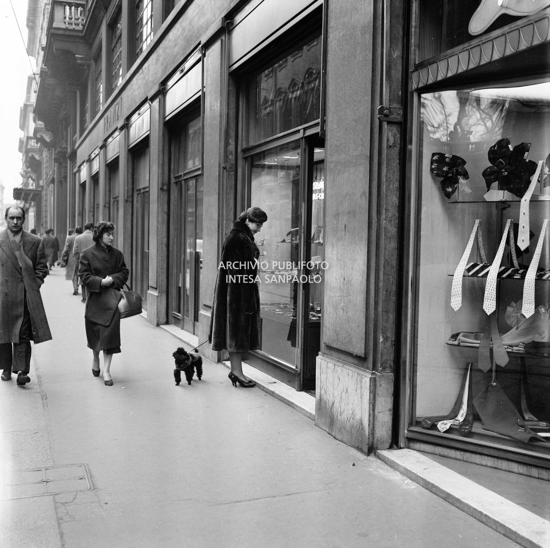 Maria Callas con il suo barboncino guarda una vetrina in via Manzoni, a Milano