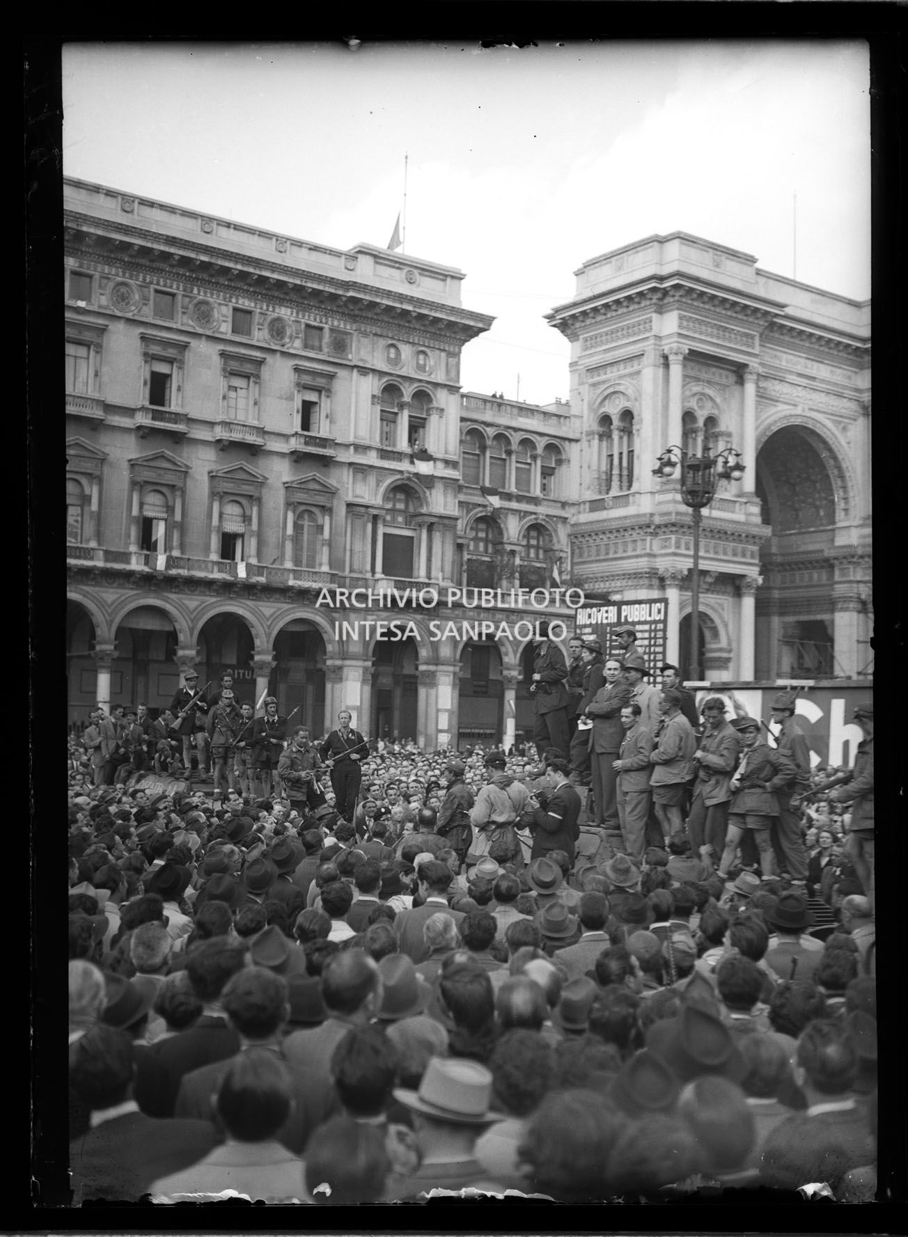 Le colonne partigiane arrivano in piazza del Duomo a Milano e dal podio improvvisato sul tetto di un blindato Cino Moscatelli parla alla folla nella quarta giornata di insurrezione generale