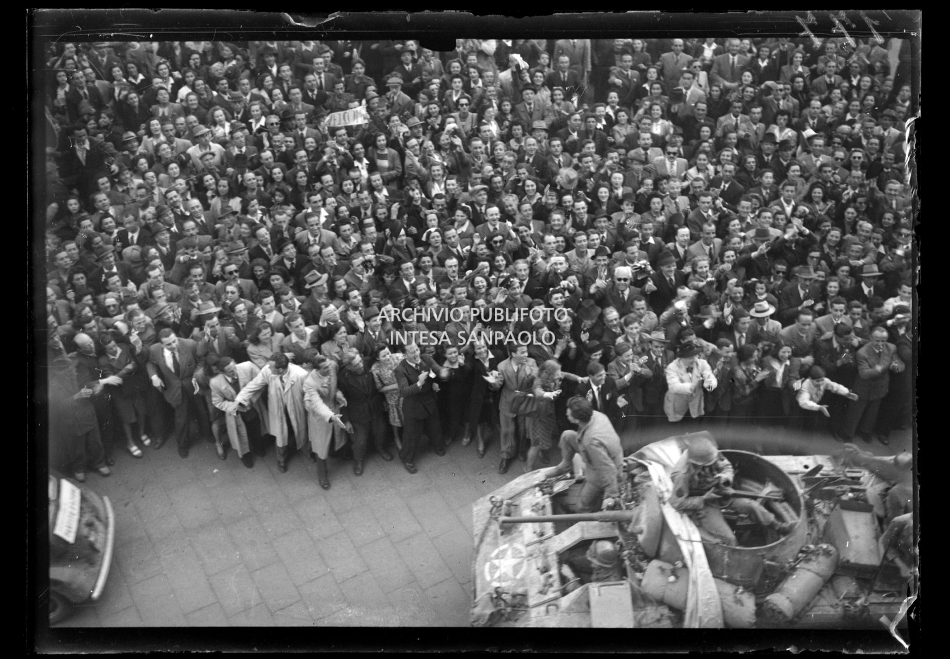 La folla festante accoglie le truppe americane in piazza del Duomo entrate trionfalmente a Milano nella settima giornata di insurrezione generale