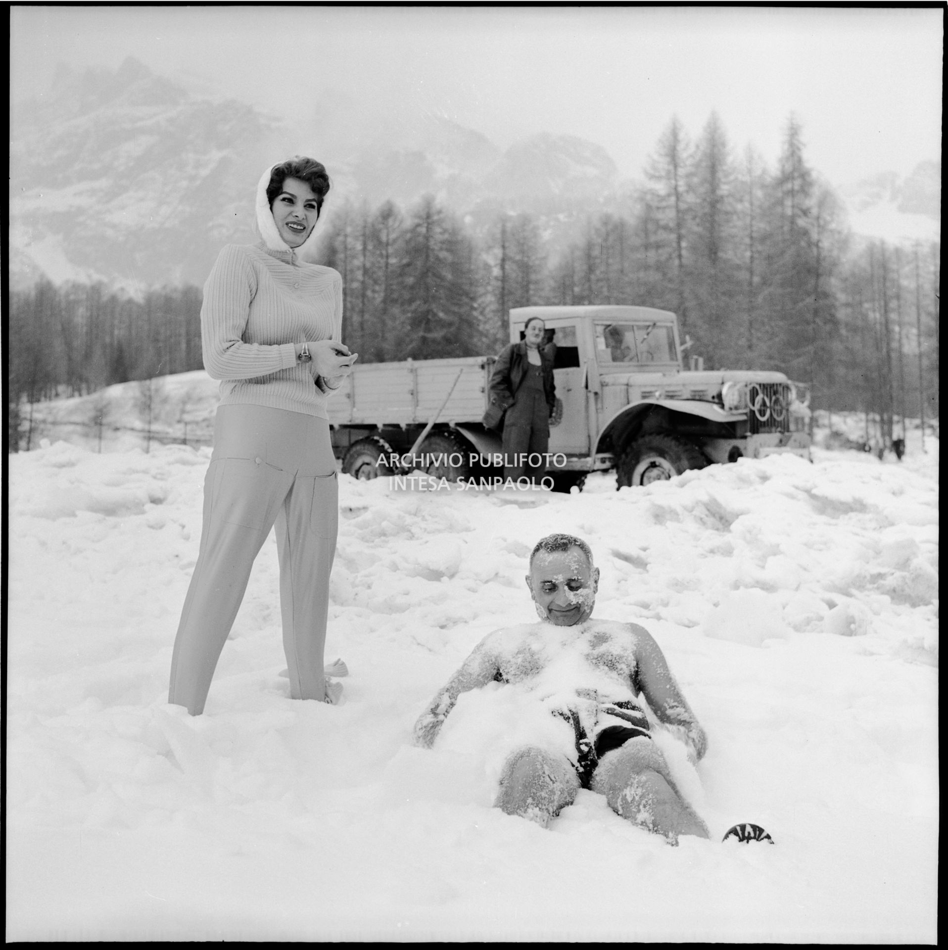 Sophia Loren, in visita a Cortina d'Ampezzo in occasione i VII Giochi olimpici invernali, a fianco al presidente dello Sci Club Terminillo in costume da bagno nella neve