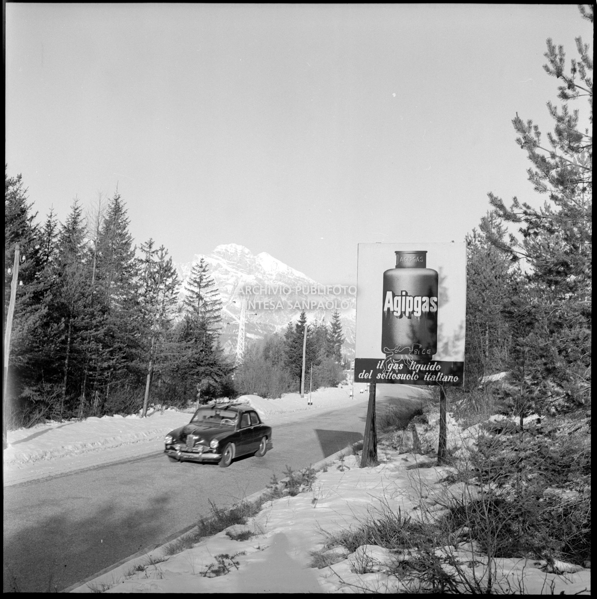 Cartello pubblicitario Agipgas nei dintorni di Cortina d'Ampezzo nei giorni dei VII Giochi olimpici invernali