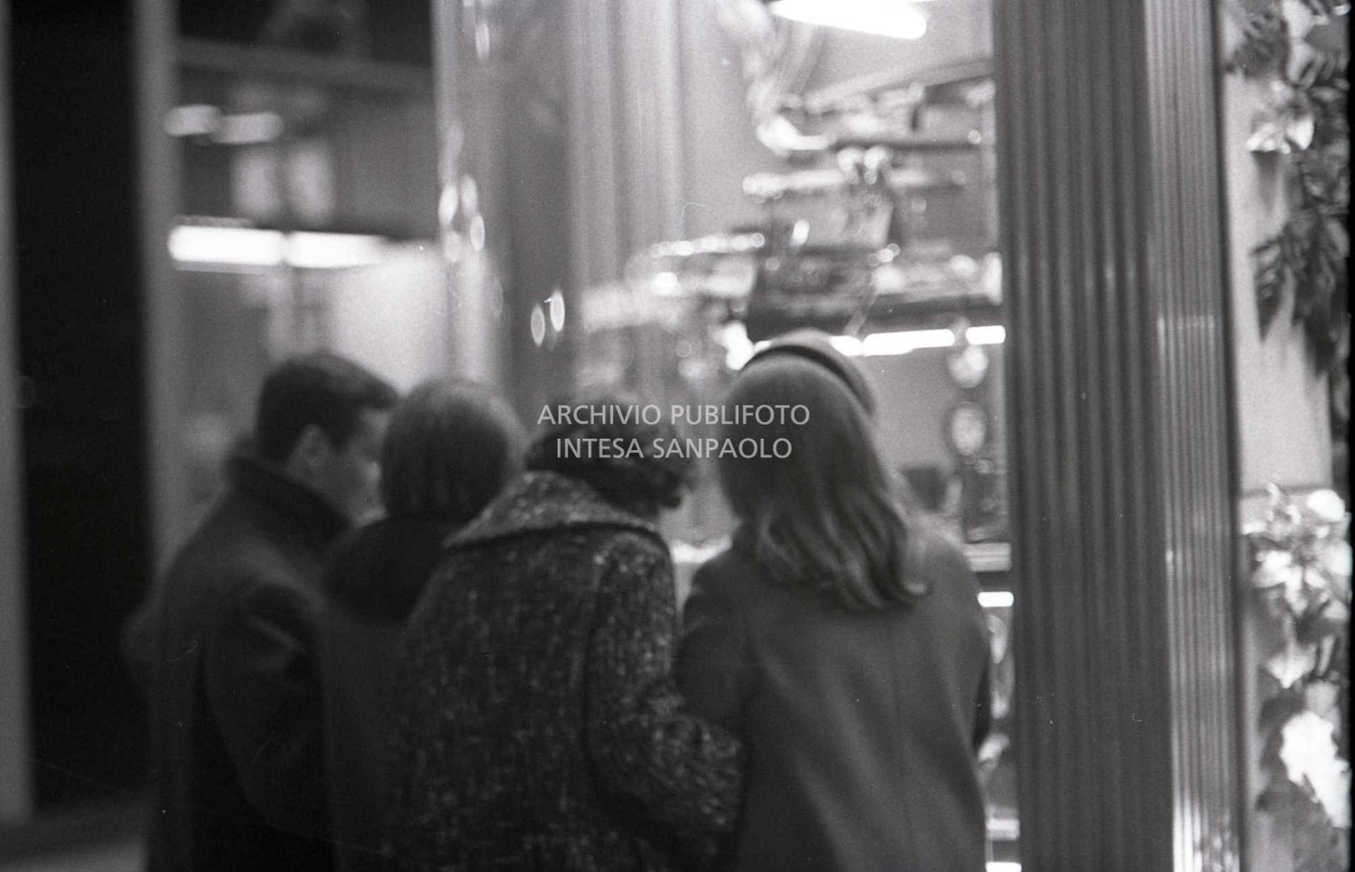 Passanti davanti alle vetrine dei negozi, a Milano, nei giorni precedenti il Natale