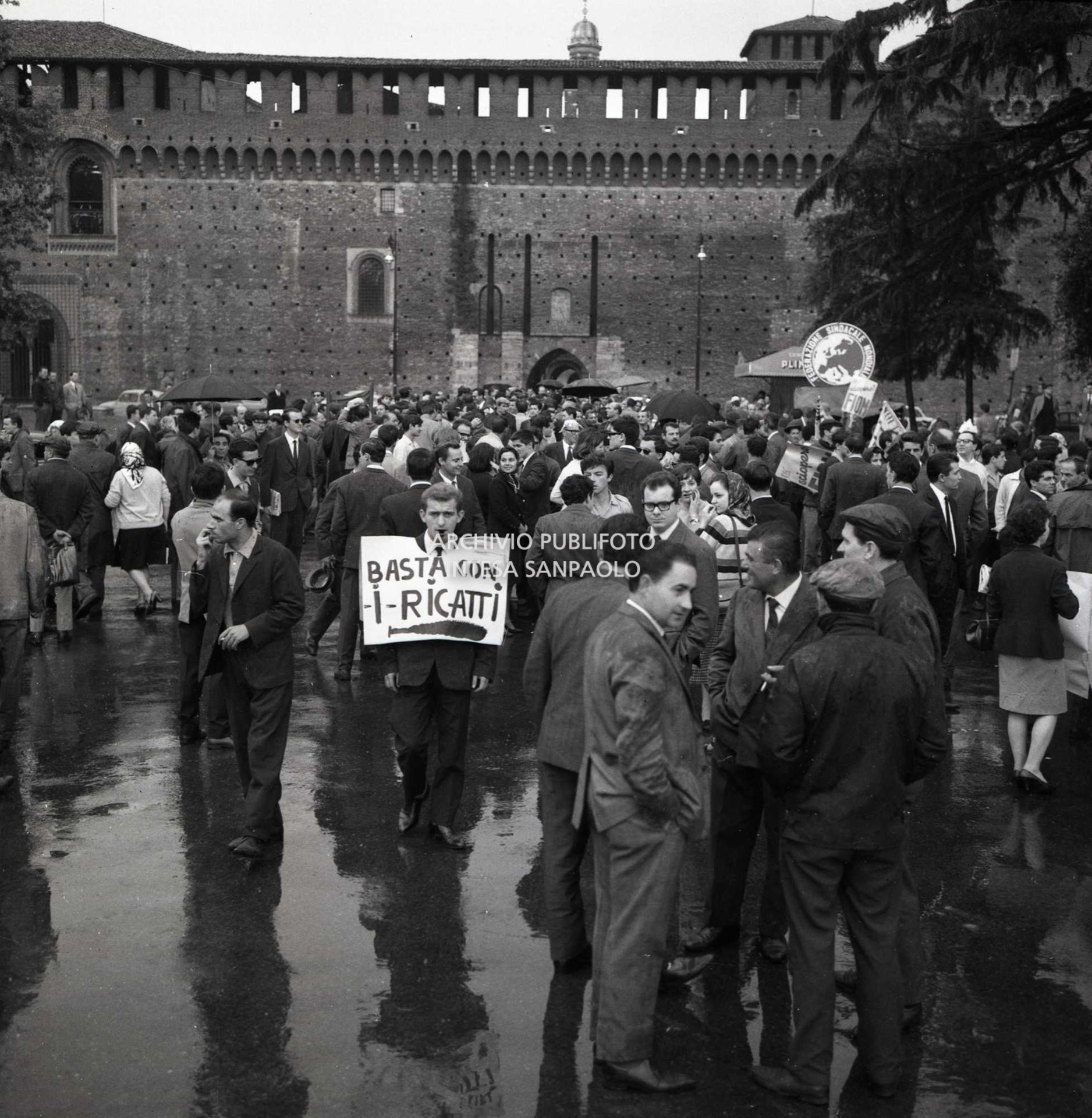 Sciopero CGIL: lavoratori in piazza del Cannone a Milano dove si è conclusa la manifestazione: uno uomo porta al collo un cartello con la scritta "Basta con i ricatti"