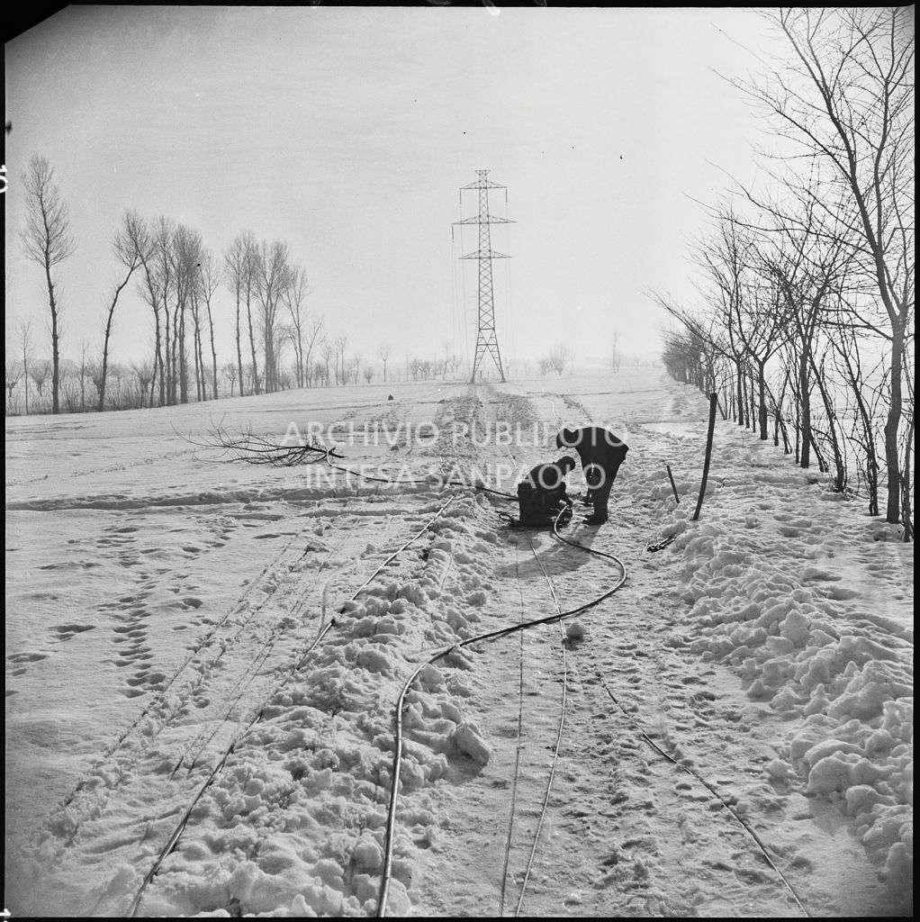 Operai al lavoro nella neve per l'allacciamento dei cavi elettrici della Edison<br>196148