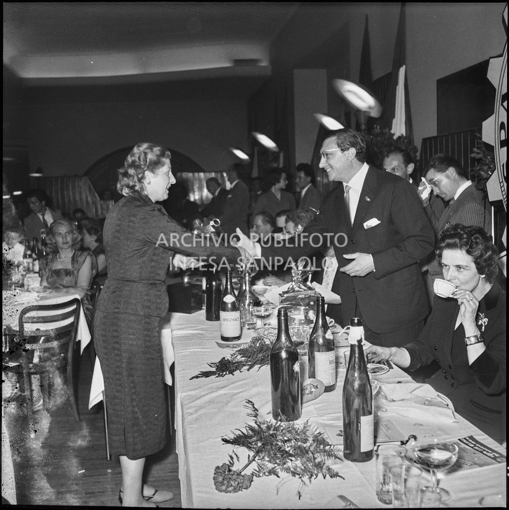 Il presidente del Vespa Club Milano Renato Tassinari stringe la mano ad una delle vincitrici della terza edizione dell'Audax internazionale vespistico femminile durante il banchetto organizzato del Vespa Club Milano<br>215338