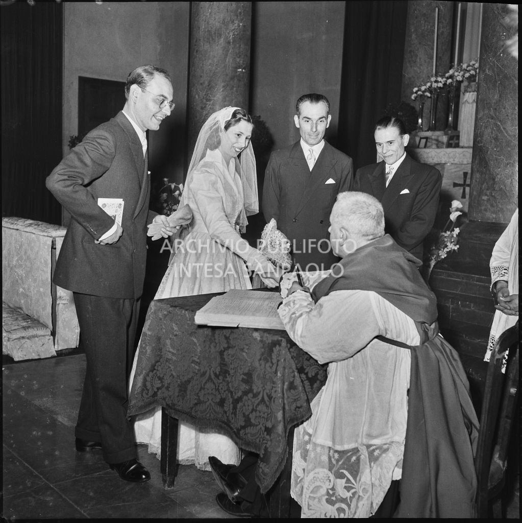 Il prete con gli sposi e i testimoni durante la compilazione del registro nuziale<br>215450