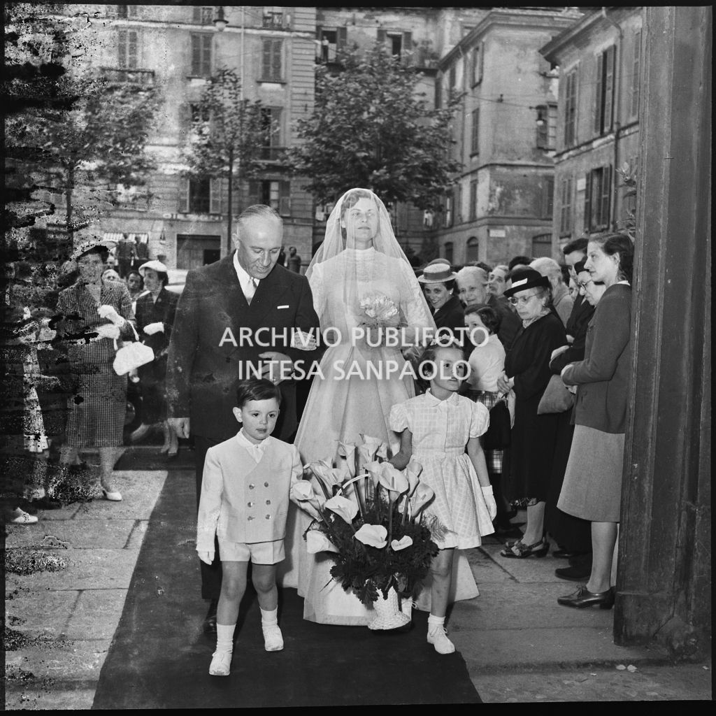 La sposa del dott. Giuseppe Pirovano e il padre sul portale della chiesa di San Marco a Milano in occasione della celebrazione della cerimonia nuziale<br>215929