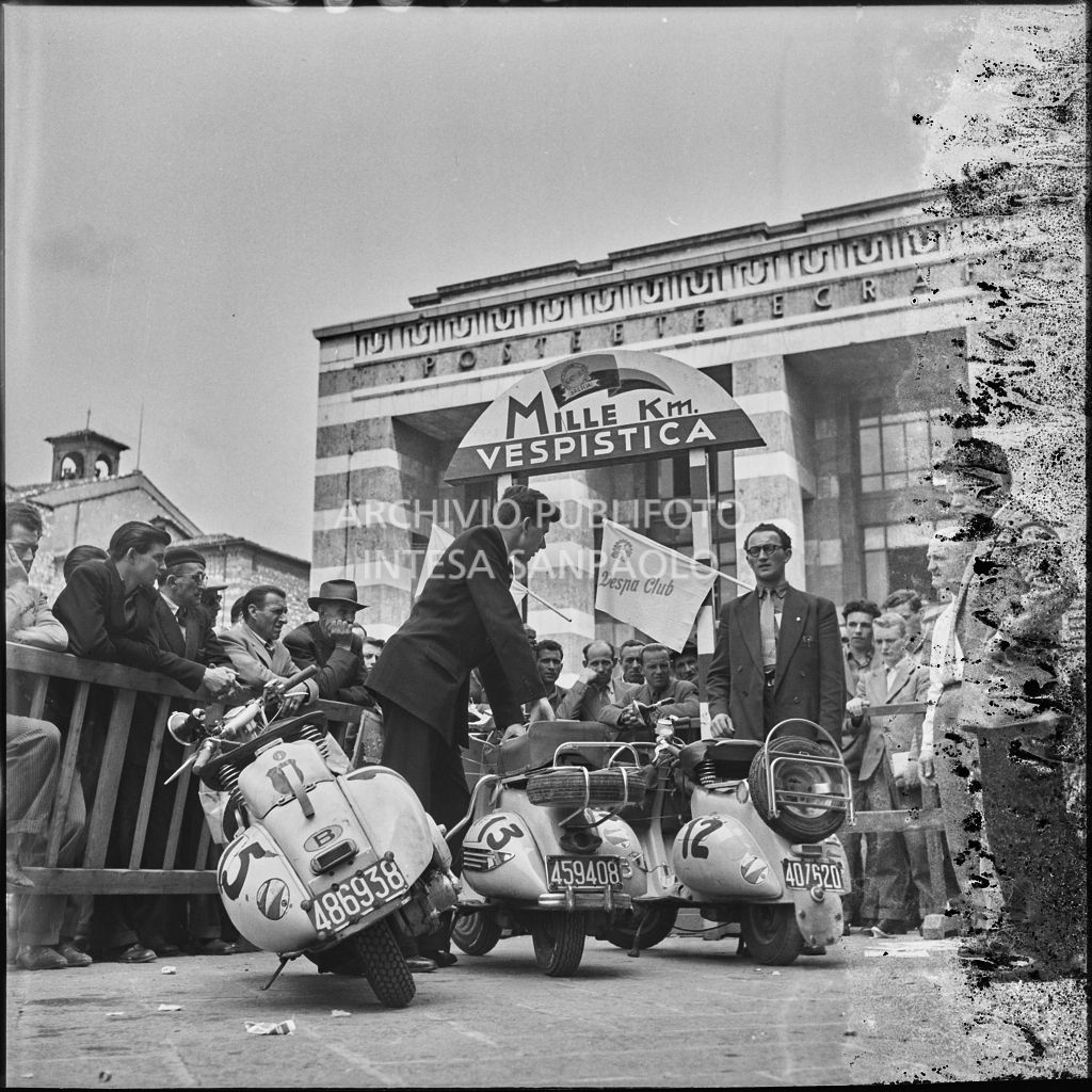 Scooter Vespa parcheggiate in piazza della Vittoria a Brescia in occasione della competizione sportiva 1000 Km Vespistica del 1954<br>216222