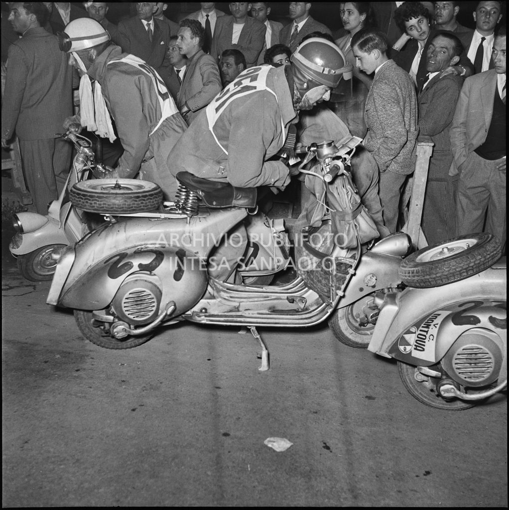 Alcuni concorrenti della competizione sportiva 1000 Km Vespistica del 1954 durante un momento di pausa<br>216402