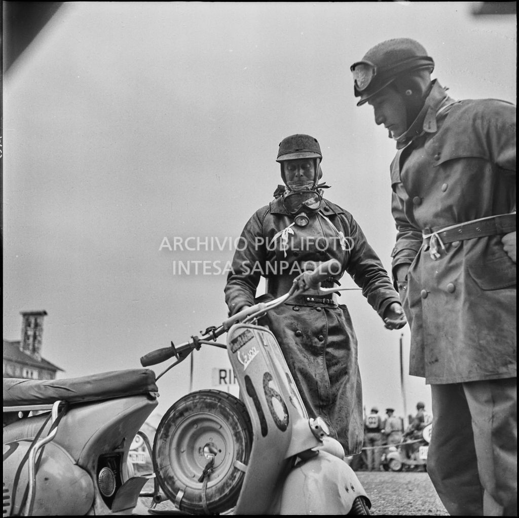 Due concorrenti della competizione sportiva 1000 Km Vespistica del 1954 durante una pausa<br>216471