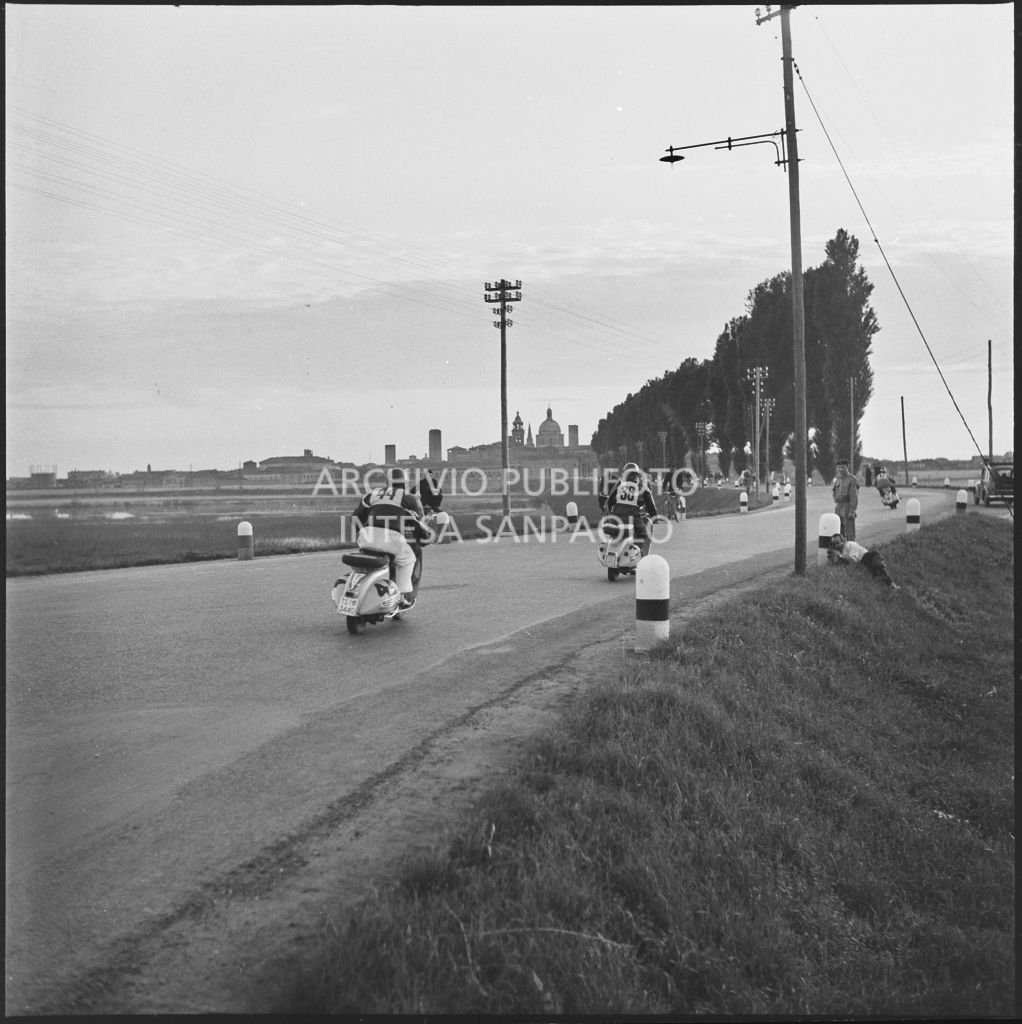 Il concorrente Ugo Miazzi del Vespa Club di Trieste (numero di gara 44) e il concorrente Osvaldo Buffalini del Vespa Club di Forlì (numero di gara 36) durante la competizione sportiva 1000 Km Vespistica del 1954<br>216501