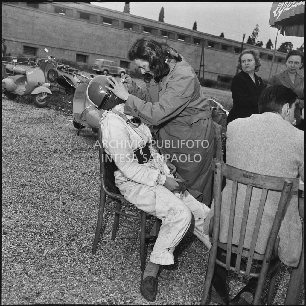 Medicazione di una concorrente durante una pausa dalla competizione sportiva 1000 Km Vespistica del 1954<br>216510