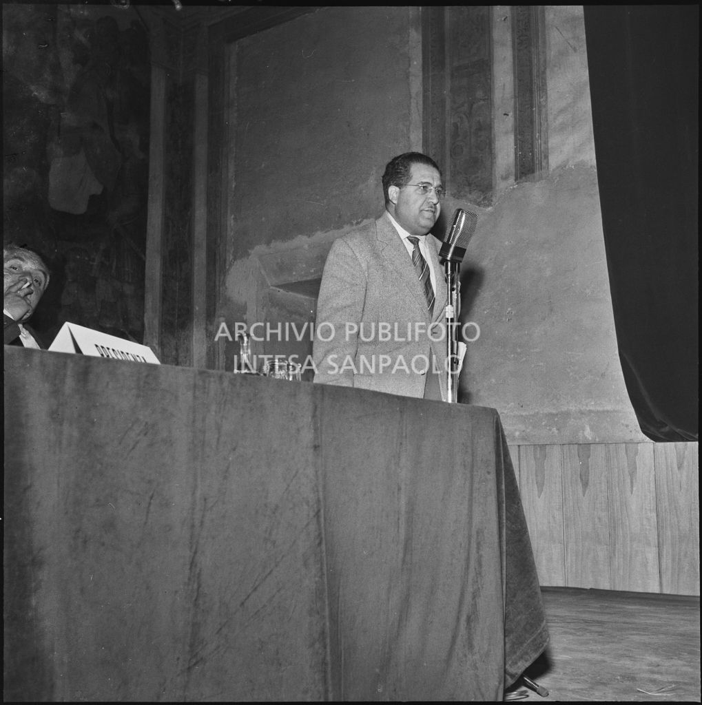 Esposizione di un relatore del convegno di studio sulle condizioni del lavoratore nell'impresa industriale organizzata dalla Società Umanitaria nei Chiostri di San Barnaba a Milano<br>216980