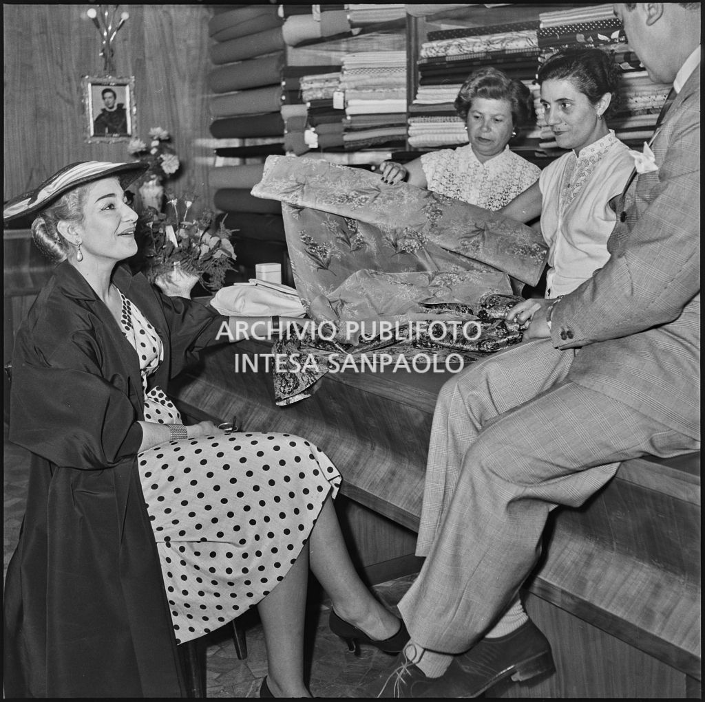 La soprano Maria Meneghini Callas e il tenore Giuseppe Di Stefano osservano alcune stoffe nel negozio "Tutto per la signora" di Milano<br>217417