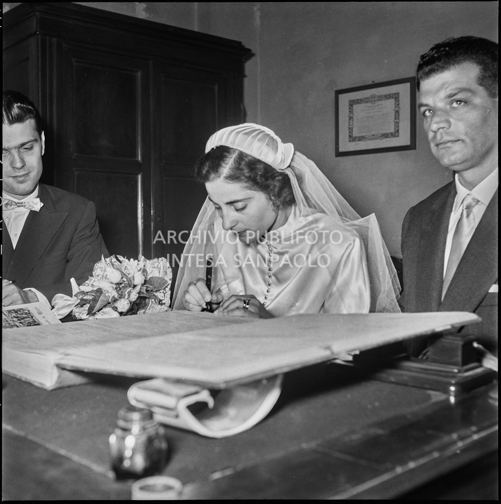 La sposa del dottor Reale firma il registro parrocchiale al temine della cerimonia nuziale<br>217438