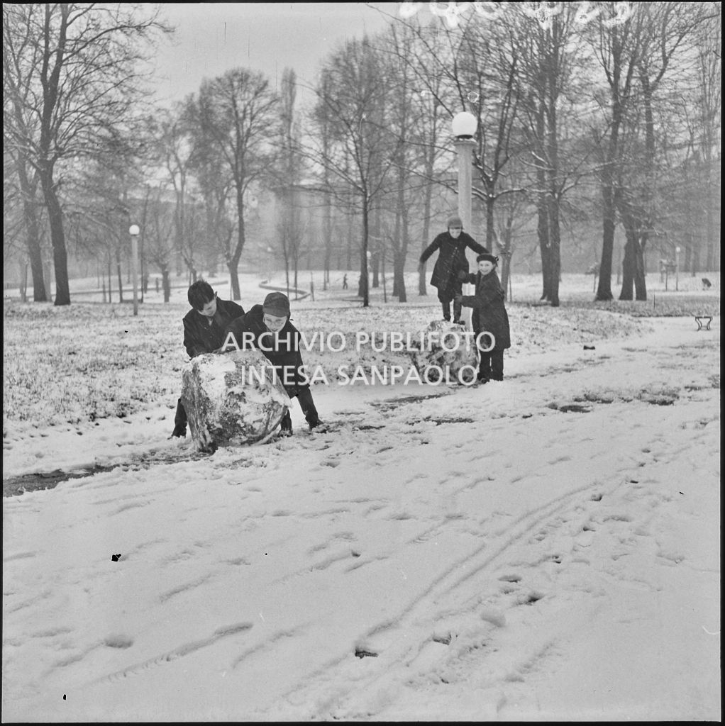 Un gruppo di bambini giocano con grandi palle da neve all'esterno del Castello Sforzesco<br>240423