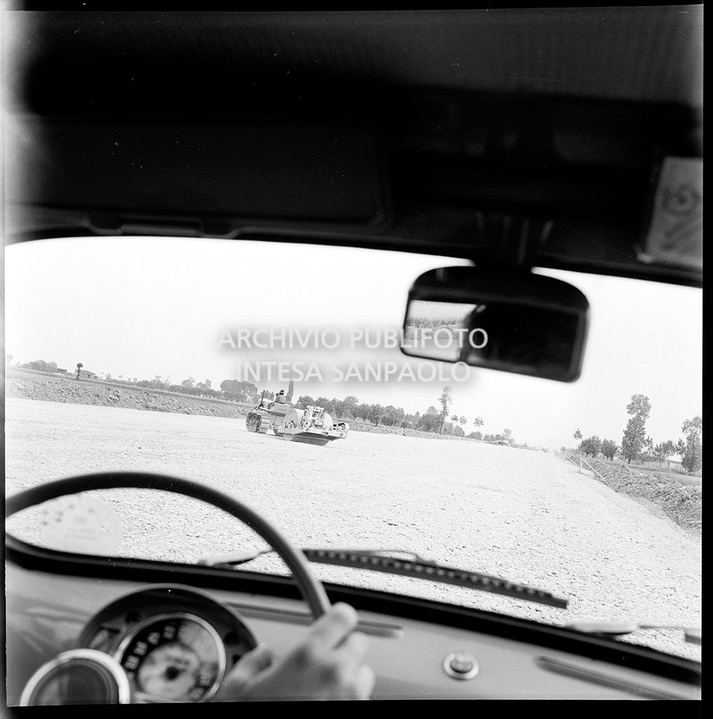 Cantiere per la costruzione dell'Autostrada del Sole nel tratto Piacenza-Pontenure visto dall'interno di una Fiat 600<br>383260