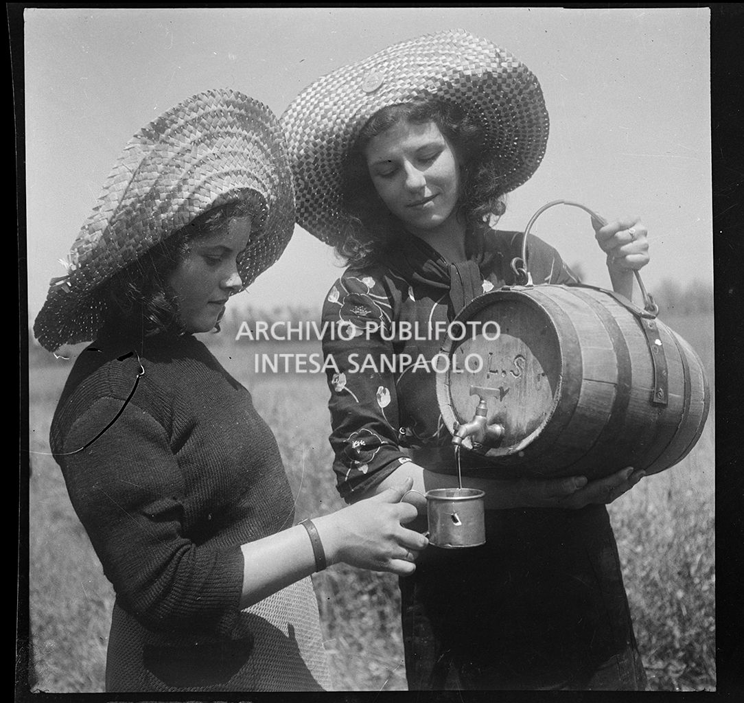 Due mondine in risaia si dissetano da una piccola damigiana<br>4560