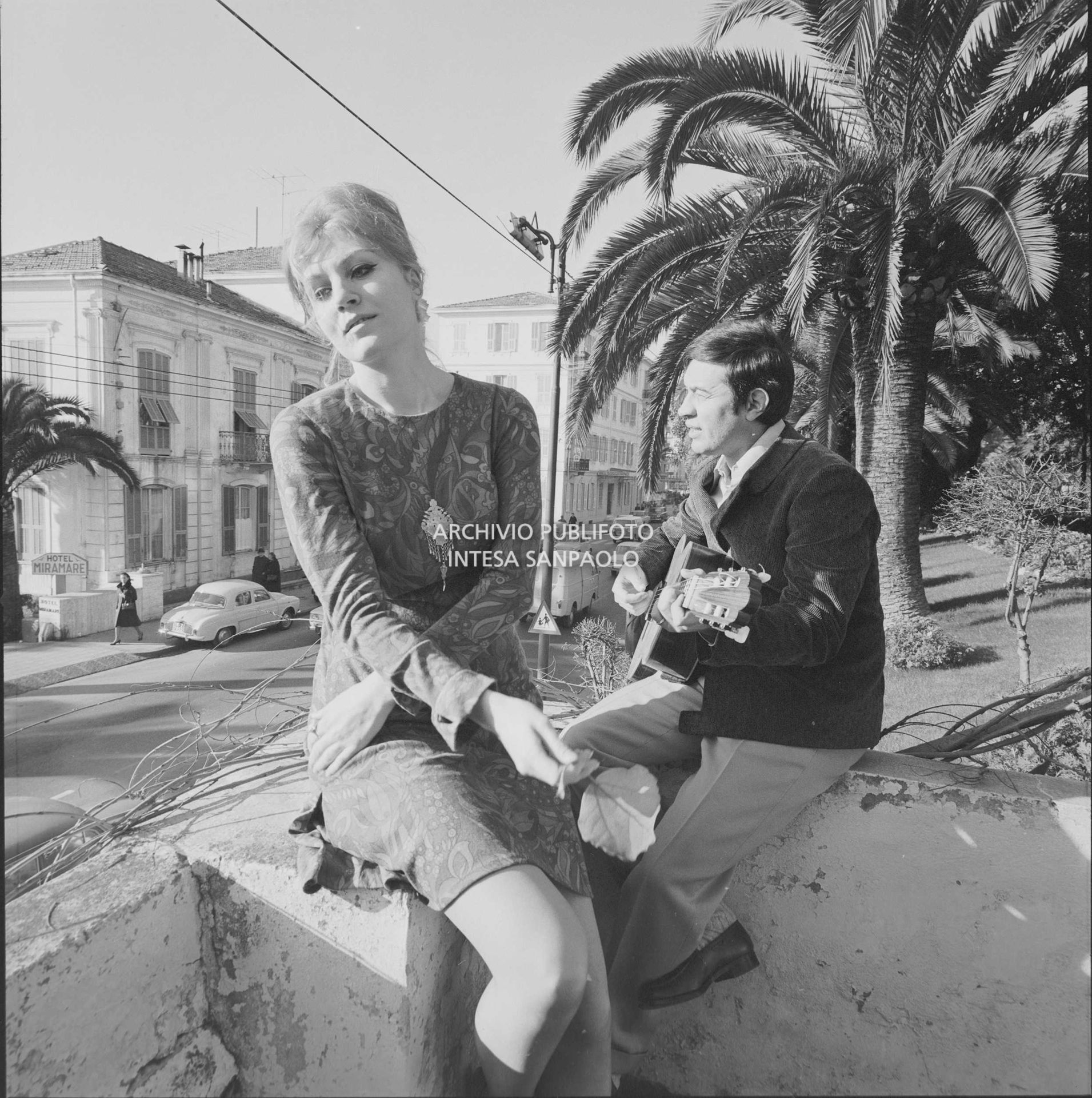 Anna German e Fred Bongusto, con la chitarra, seduti su un muretto a Sanremo nei giorni del Festival