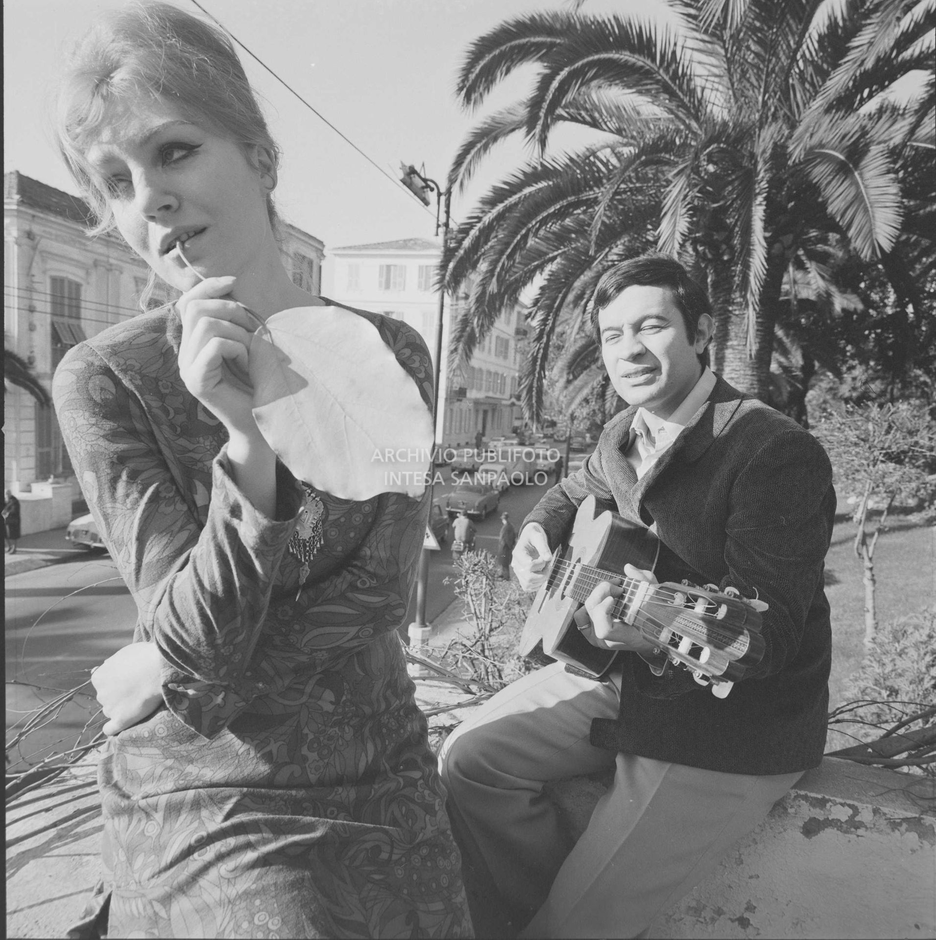 Anna German e Fred Bongusto, con la chitarra, seduti su un muretto a Sanremo nei giorni del Festival