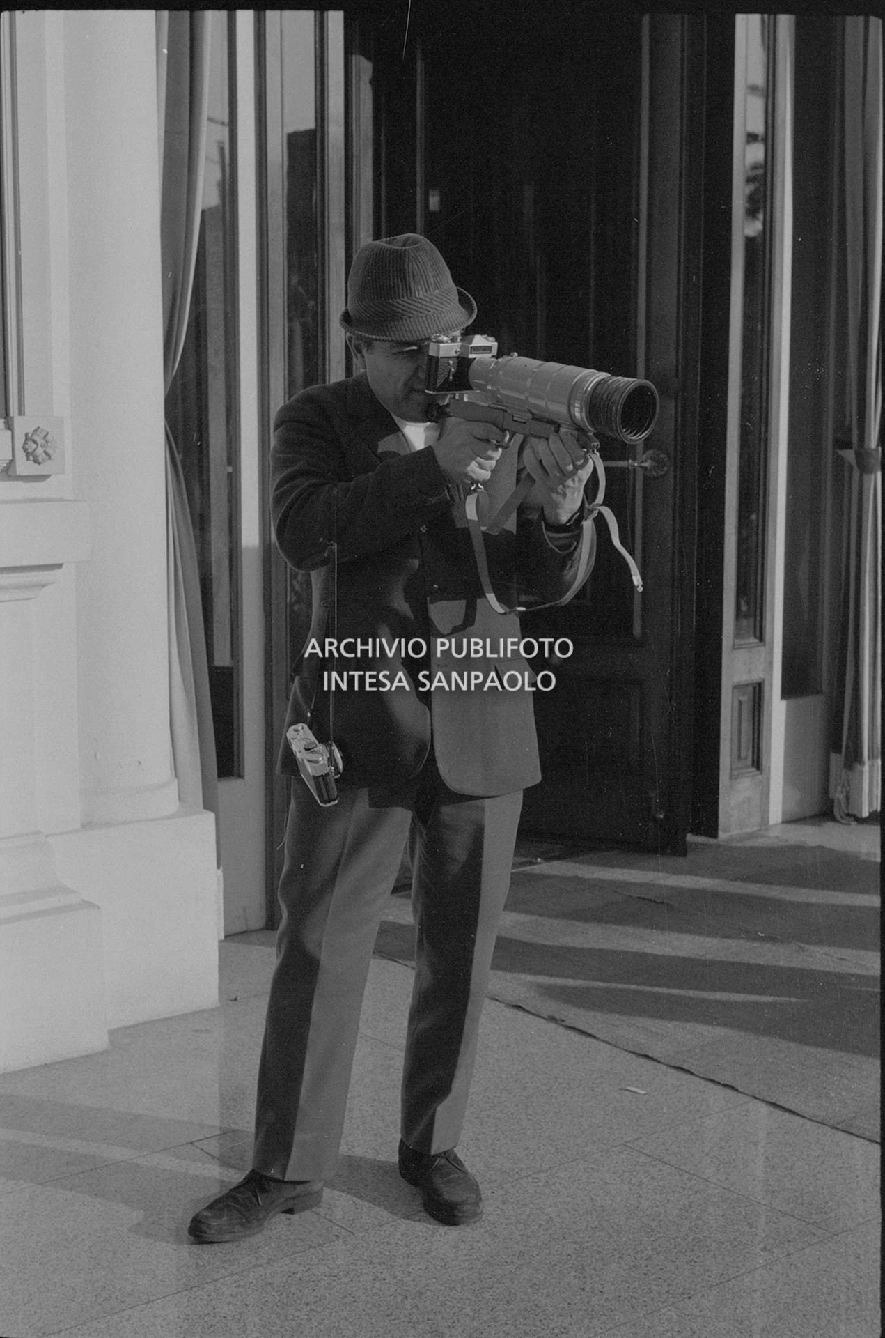 Claudio Villa, in veste di fotoreporter, all'esterno del Casinò nei giorni del XVIII Festival della canzone italiana di Sanremo