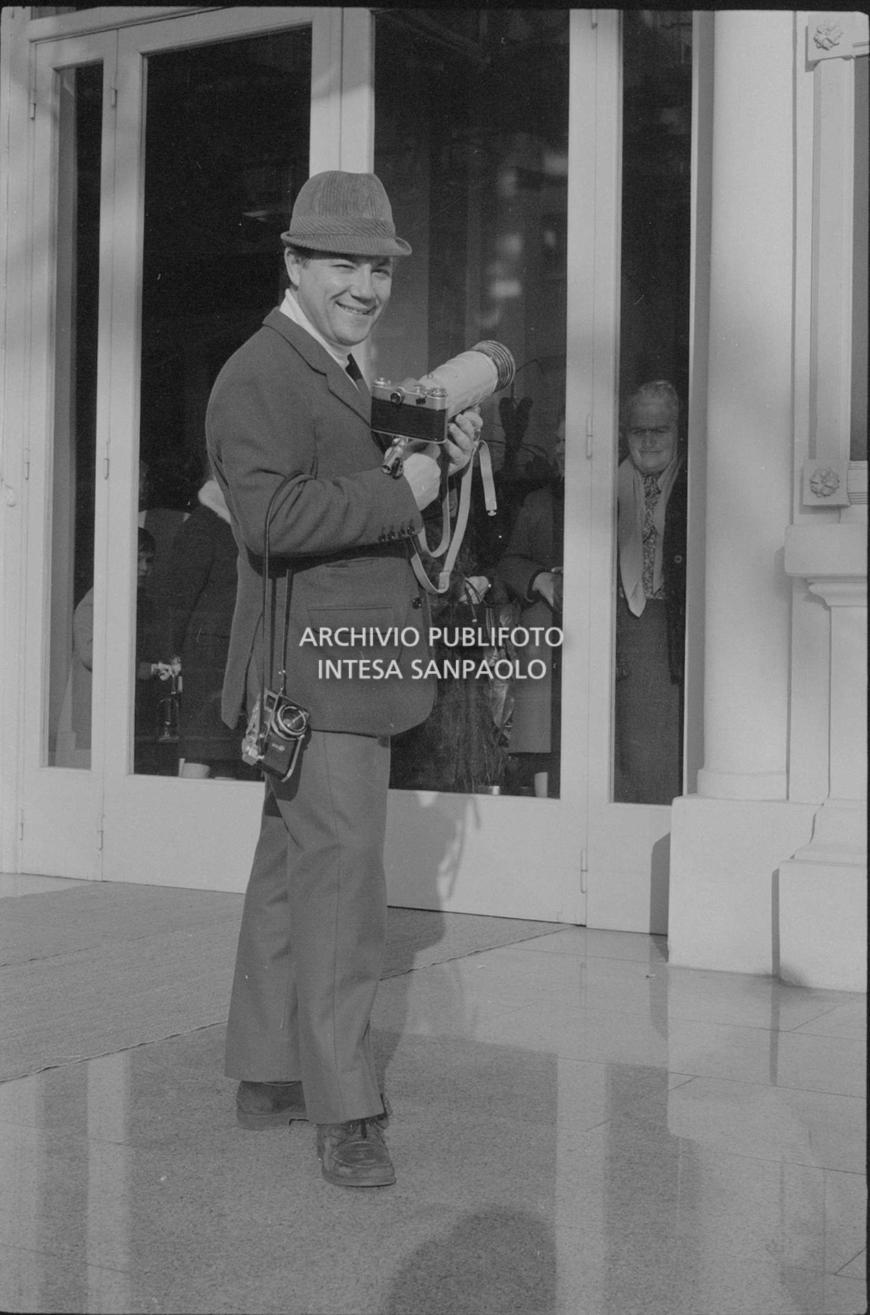 Claudio Villa, in veste di fotoreporter, all'esterno del Casinò nei giorni del XVIII Festival della canzone italiana di Sanremo