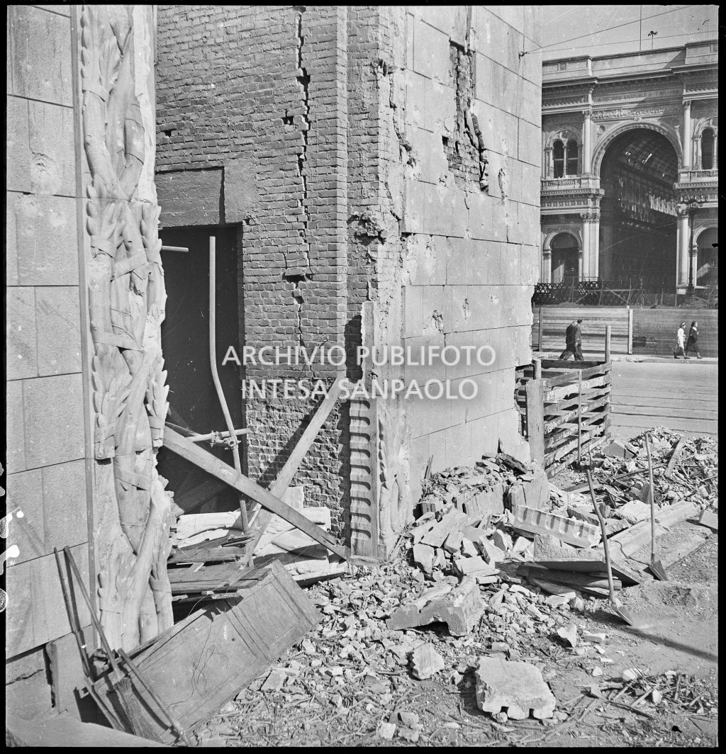 Particolare di uno dei portali rettangolari del Palazzo dell'Arengario, con cornici a motivo vegetale intrecciato dello scultore Arturo Martini, danneggiato dai bombardamenti; visibile in secondo piano la Galleria Vittorio Emanuele II