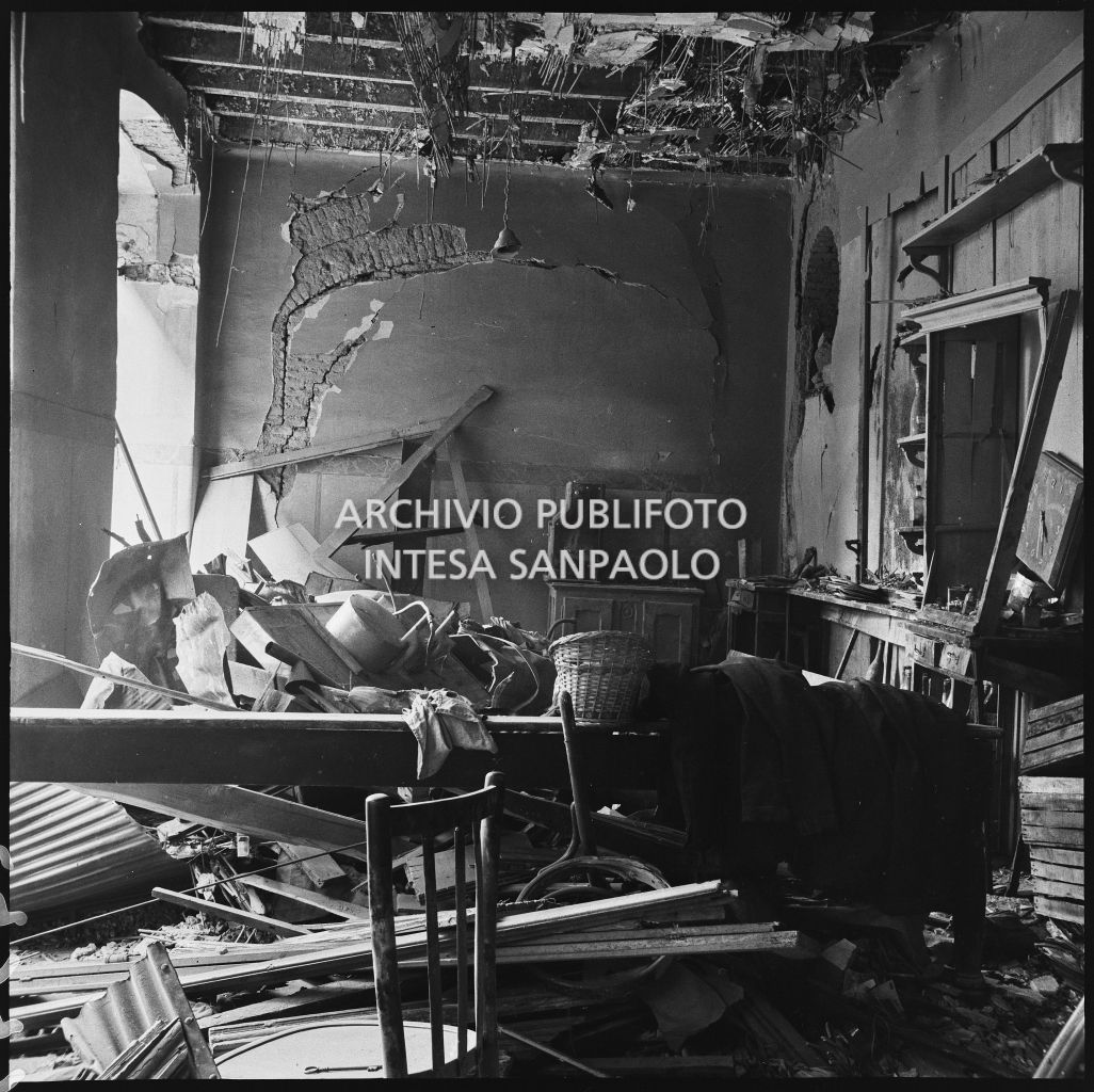 Interno di un edificio danneggiato dai bombardamenti, in via Settala a Milano, ingombro di macerie e arredi